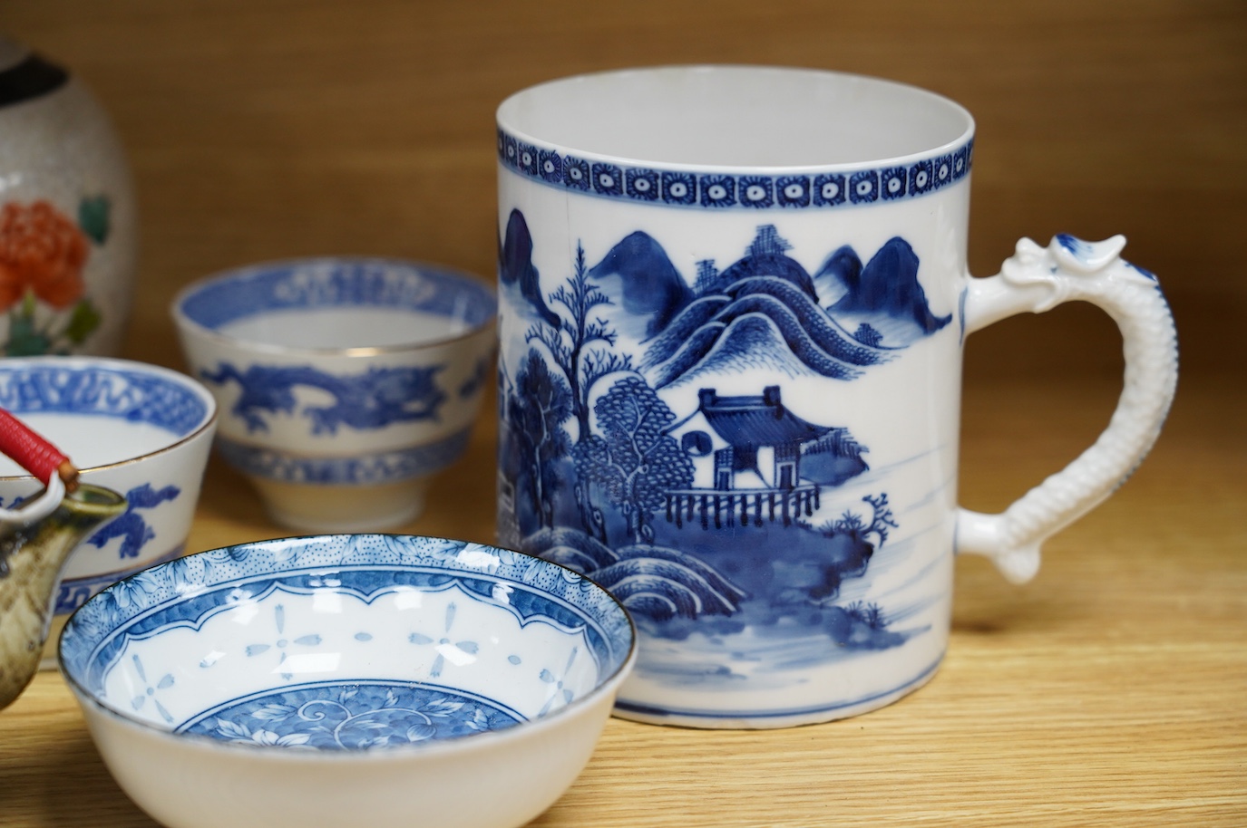 A collection of Chinese and Japanese ceramics to include tea bowls, a blue and white mug and teapot in the form of a shell, largest 13cm high. Condition - mostly good